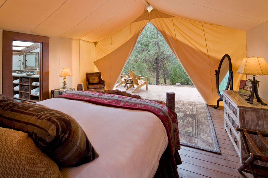 a glamping tent with a bed